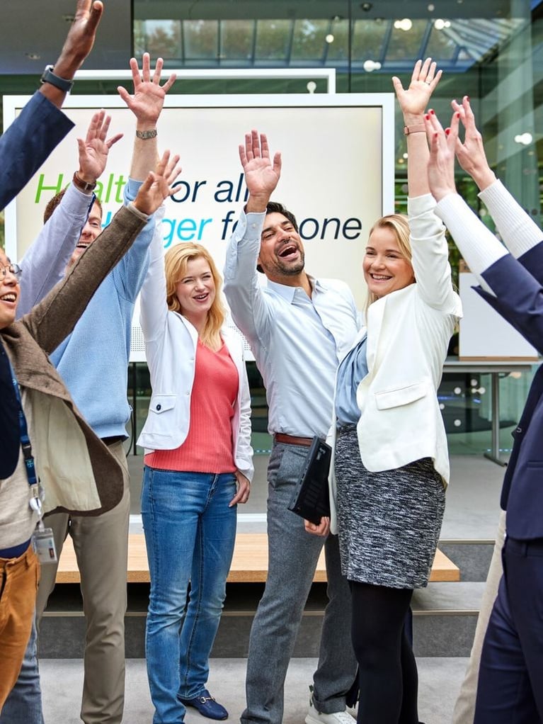 employees-raise-their-arms.jpg