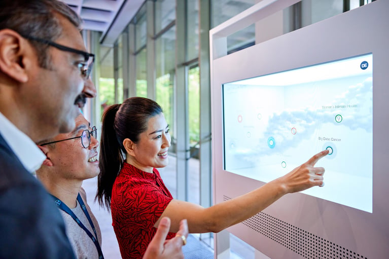 bayer employees at a touchscreen 2