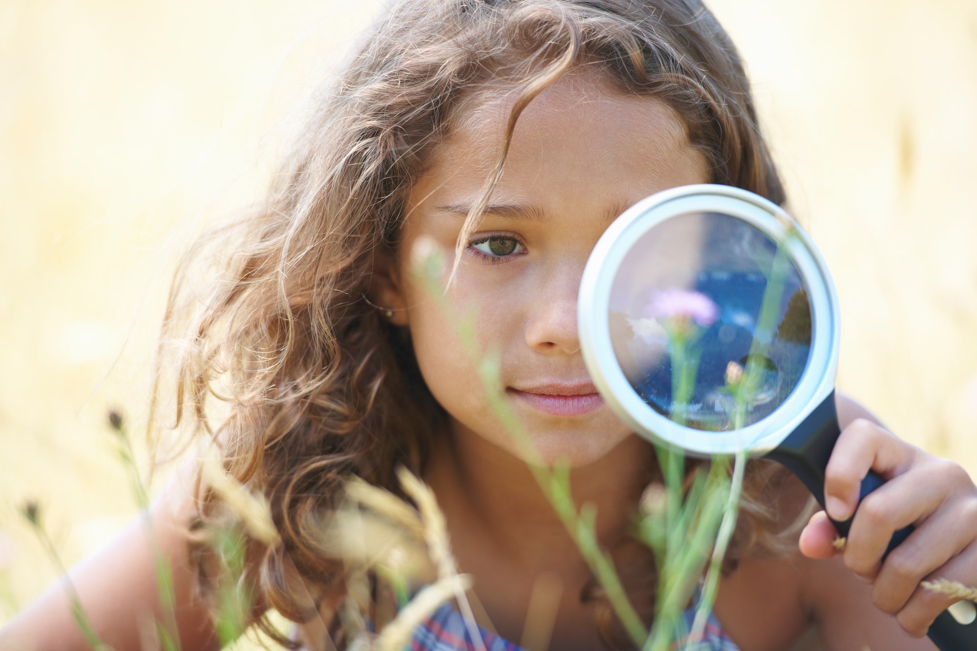Girl playing with magnifyer