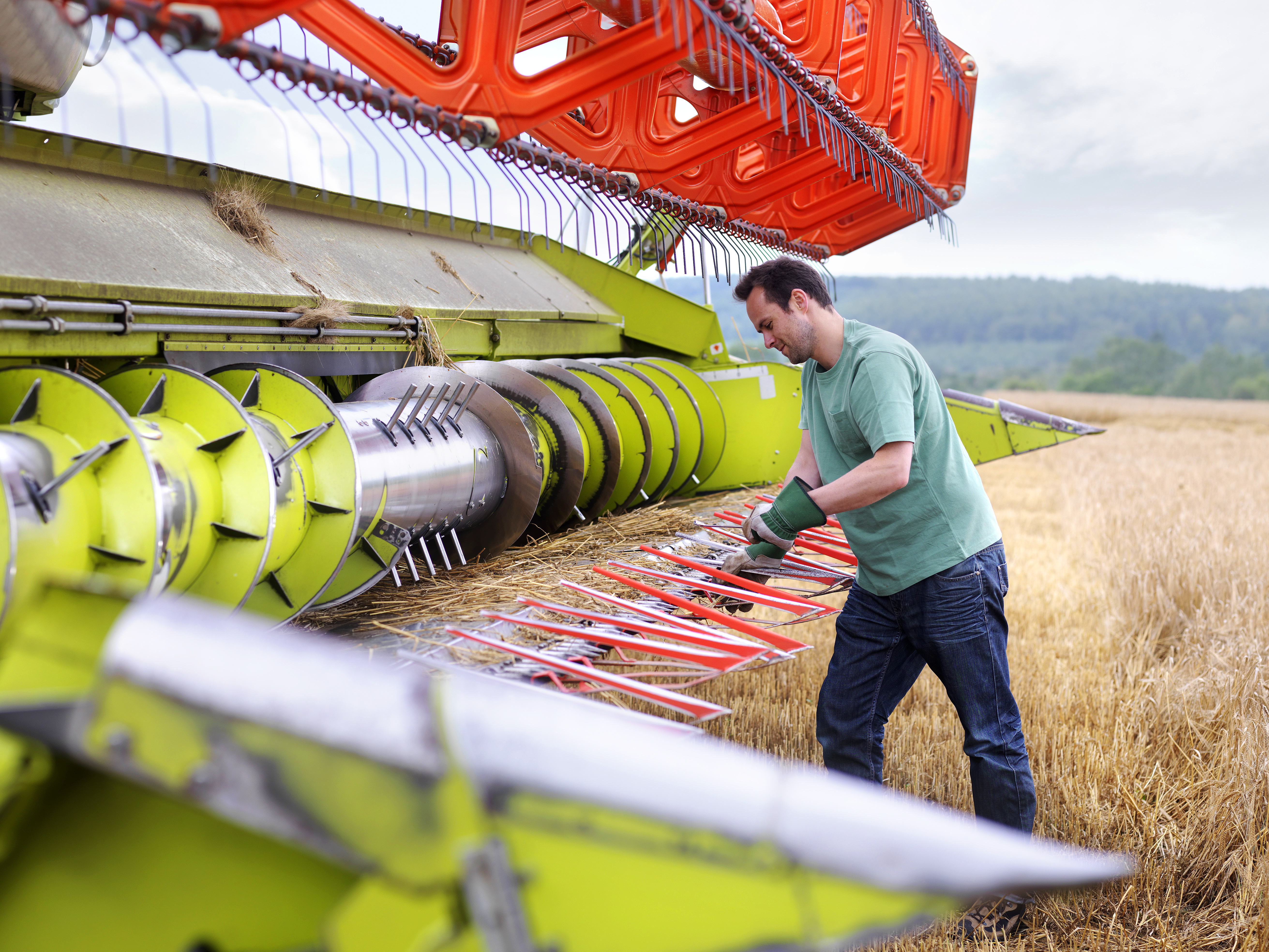 farmer_doing_maintenance_on_harvester.jpg
