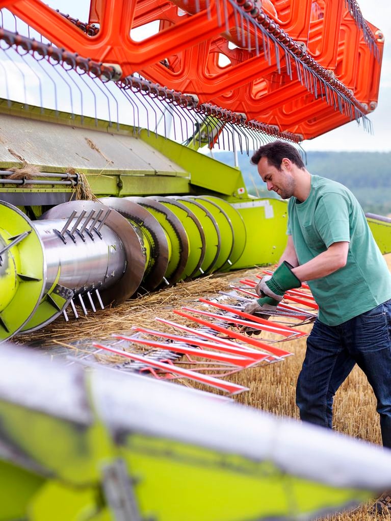 farmer_doing_maintenance_on_harvester.jpg