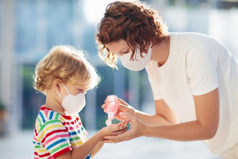 Mother and child disinfecting hands 1