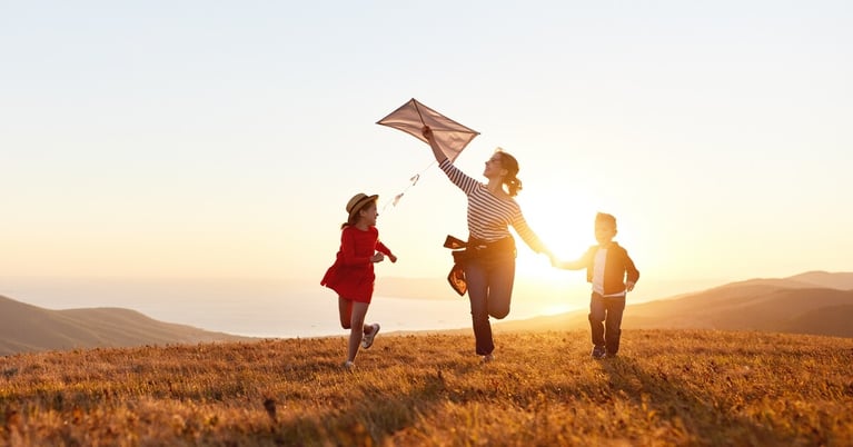 mother and children launch a kite