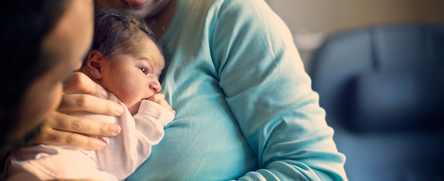 Mother_holding_newborn_1440x590.jpg