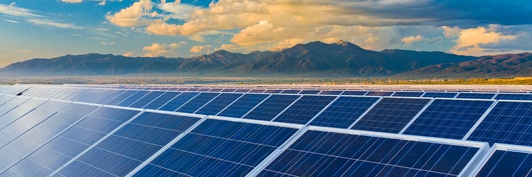 mountains-behind-solar-panels.png
