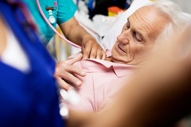 Nurse listening to patients heartbeat