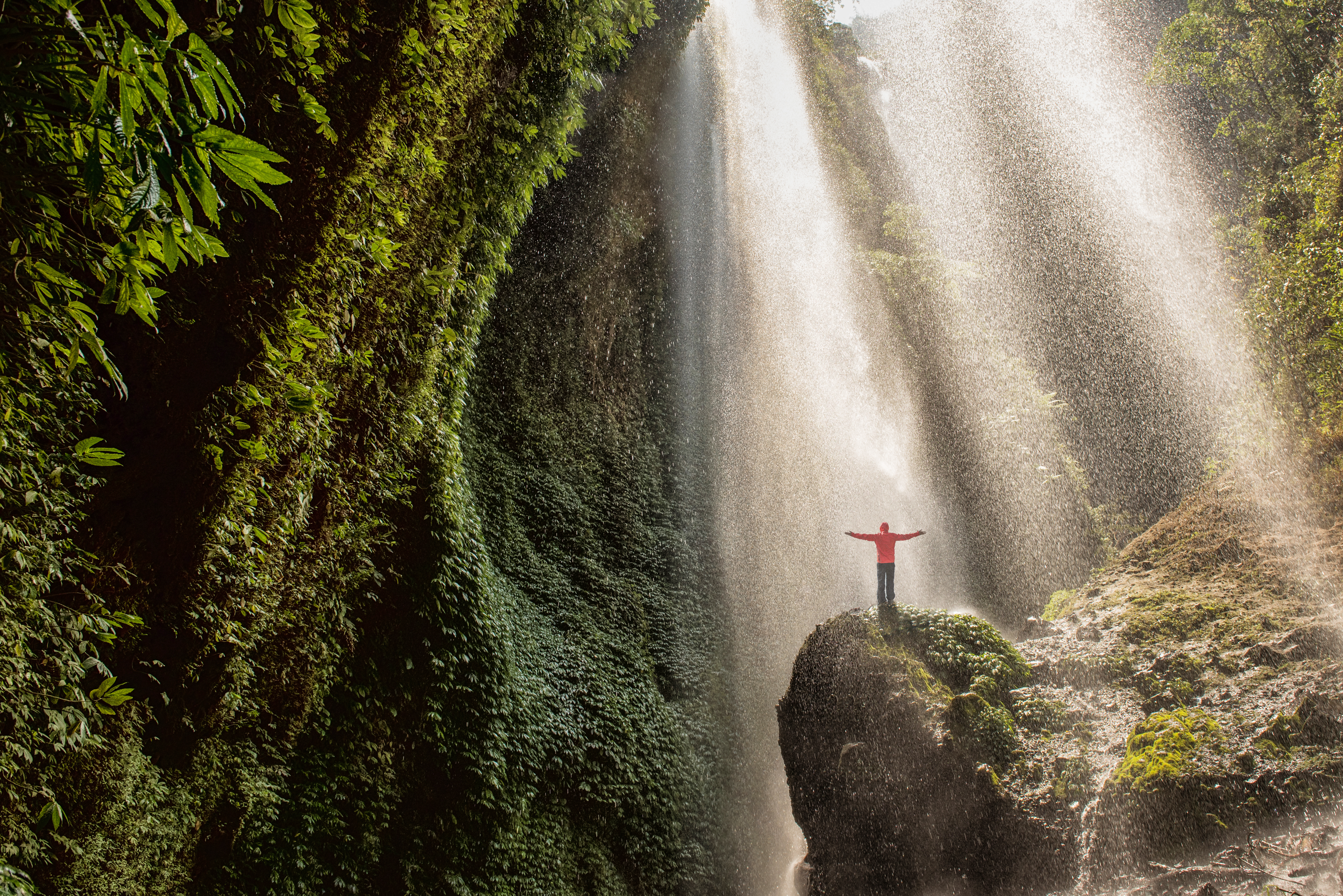person_standing_at_a_waterfall.jpeg