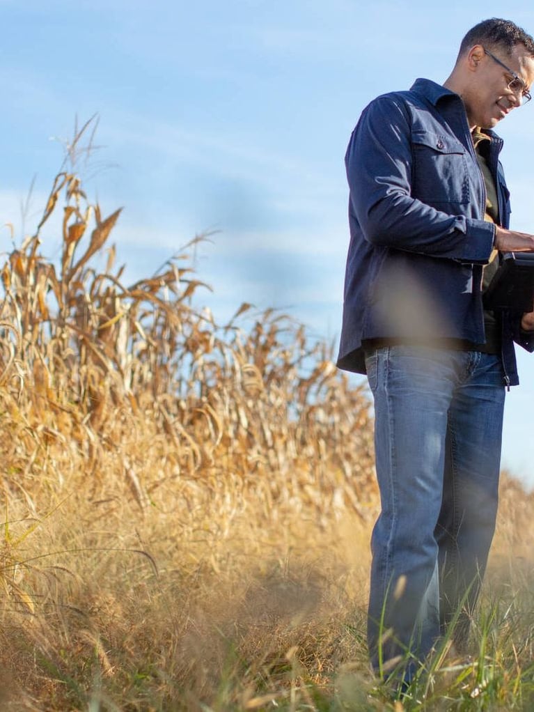 Plant_experts_reviewing_data_in_a_cornfield_right.jpg
