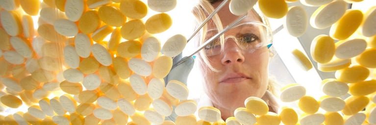 researcher-with-aspirin-tablet-1440x480.jpg