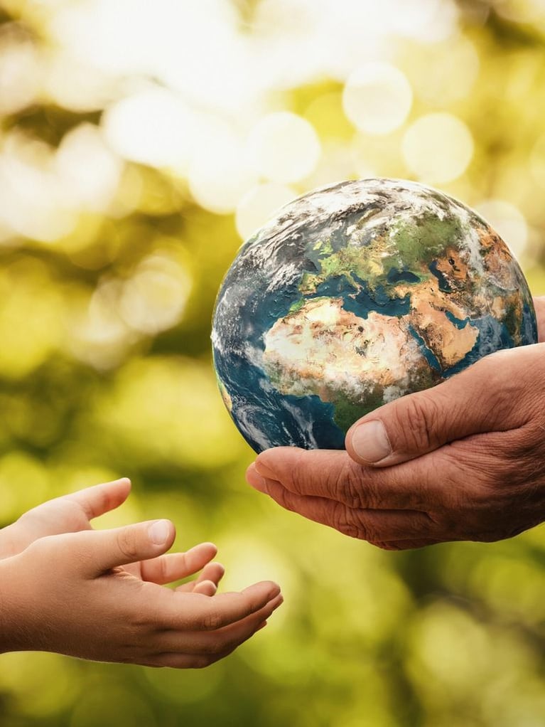 senior_hands_giving_earth_to_a_child_0.jpg