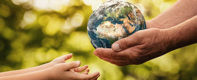 Senior_hands_giving_earth_to_a_child_1440x590.jpg