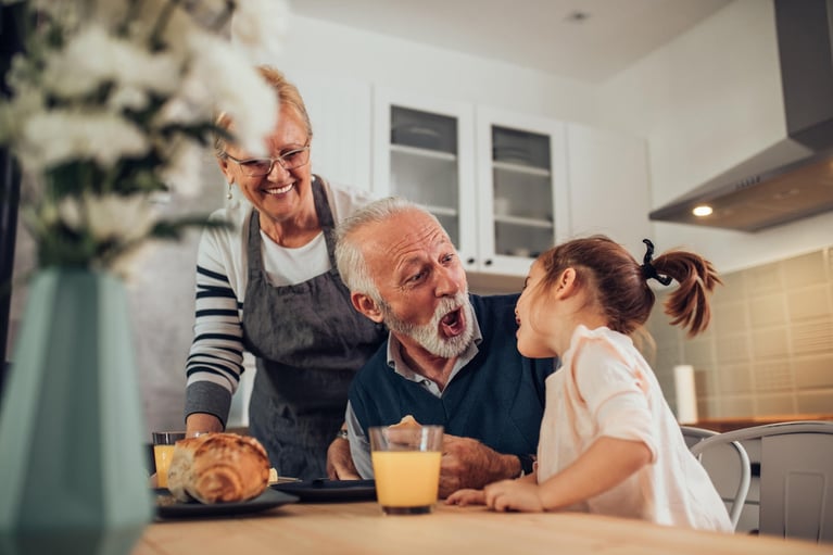 senior_man_having_fun_with_granddaughter.jpg