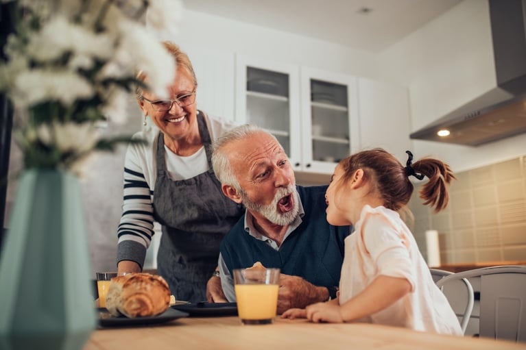senior_man_having_fun_with_granddaughter.jpg