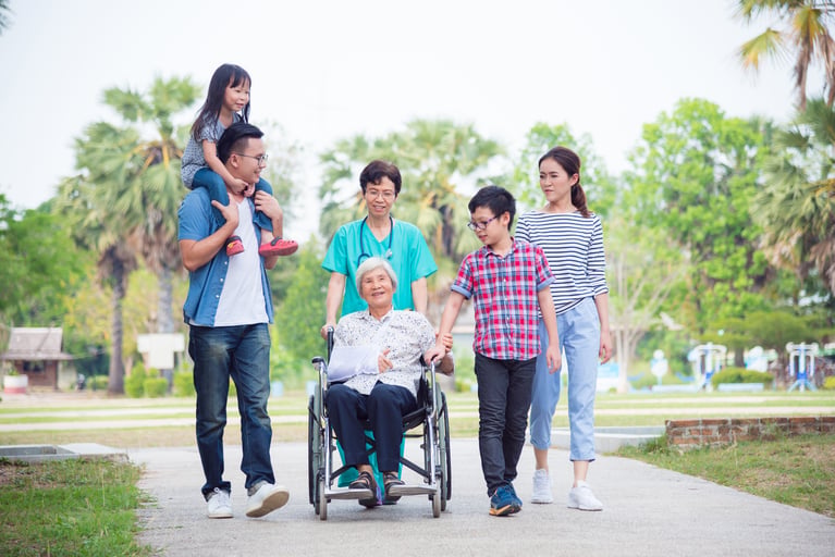 senior_woman_in_wheelchair_with_family.jpg
