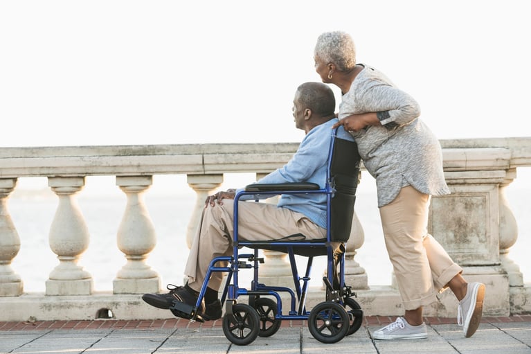 senior_woman_with_husband_in_wheelchair.jpg