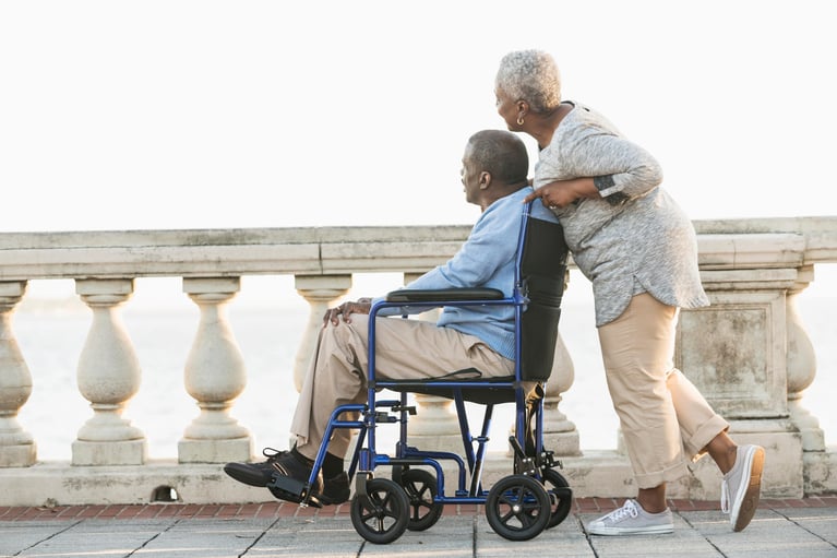 senior_woman_with_husband_in_wheelchair.jpg