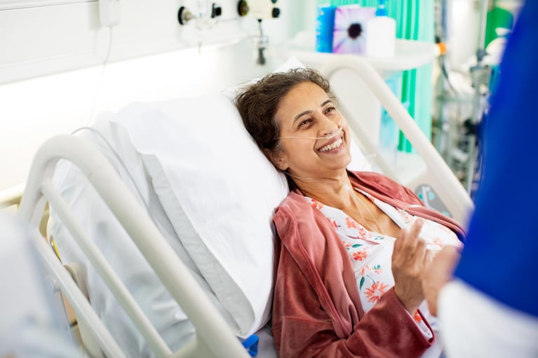 smiling-patient-in-hospital-bed.jpg