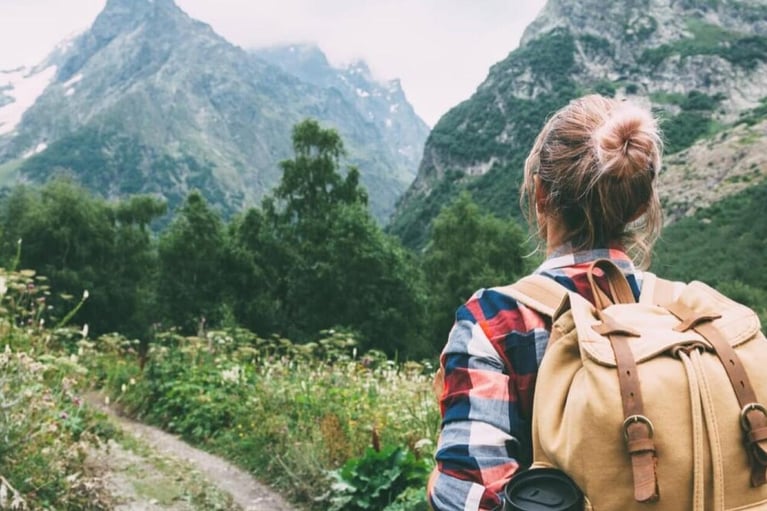 Young_woman_hiking_in_mountains.jpg